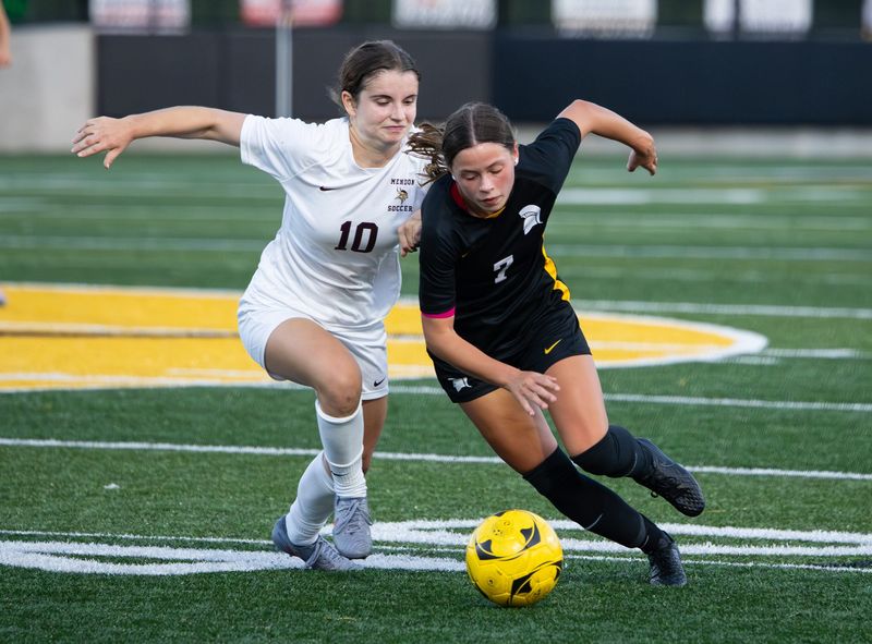 Greece Athena's Haley Drake makes a move around Pittsford Mendon's Jaelyn Rodi on Thursday, Sept. 11 at Greece Athena High School.