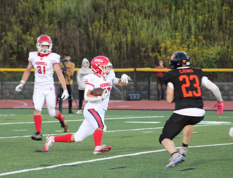 Hornell kick returner Brenton Booth looks to evade Wellsville's Gabe Black Friday, Sept. 12, 2025.