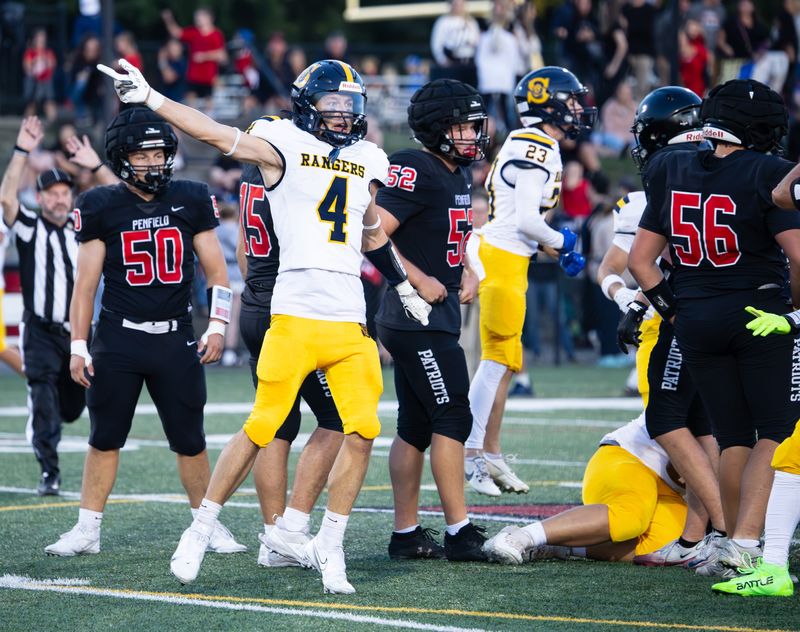 Spencerport's Jaedon Ford signals for a fumble recovery Friday, Sept. 12 at Penfield High School.