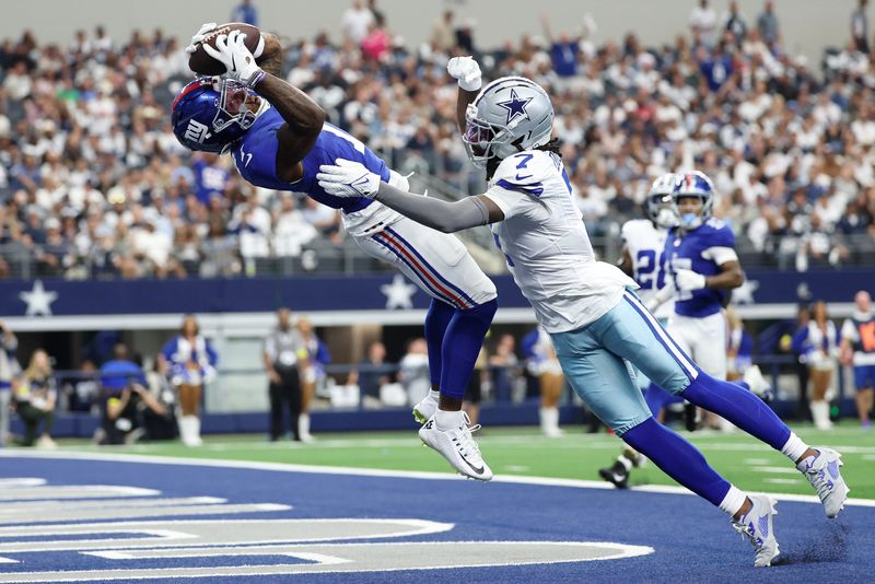 Sep 14, 2025; Arlington, Texas, USA; New York Giants wide receiver Malik Nabers (1) makes a catch for a touchdown against Dallas Cowboys cornerback Trevon Diggs (7) during the second quarter at AT&T Stadium. Mandatory Credit: Kevin Jairaj-Imagn Images