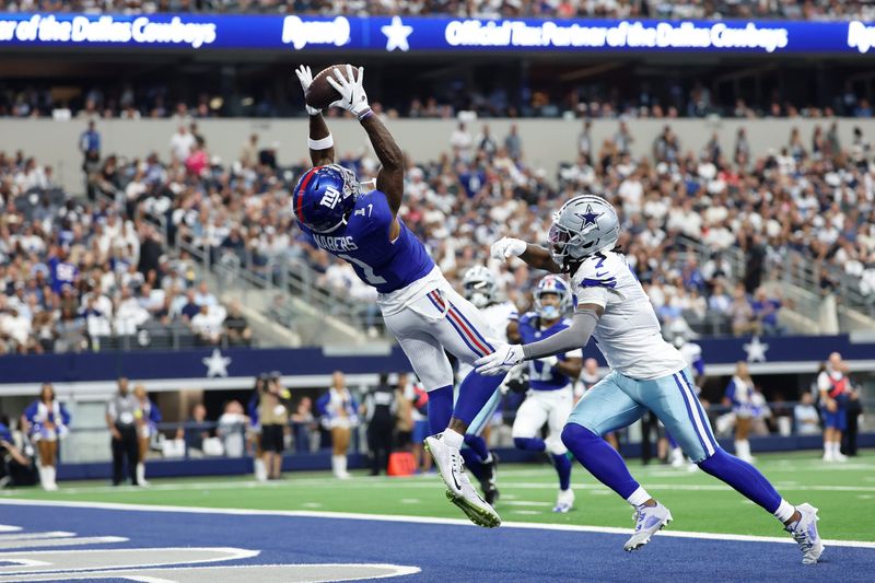 Sep 14, 2025; Arlington, Texas, USA; New York Giants wide receiver Malik Nabers (1) makes a catch for a touchdown against Dallas Cowboys cornerback Trevon Diggs (7) during the second quarter at AT&T Stadium. Mandatory Credit: Kevin Jairaj-Imagn Images