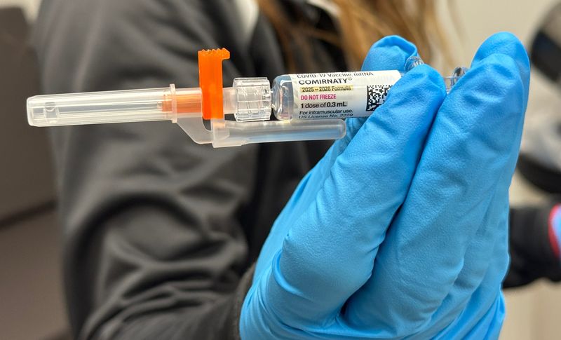 A pharmacy employee holds a vial of the updated COVID-19 vaccine made by Pfizer, Friday, Sept. 5, 2025.