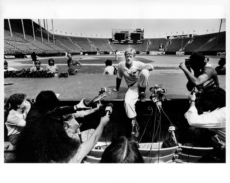 Robert Redford talks to reporters during a break in filming of "The Natural" in Buffalo's War Memorial Stadium.