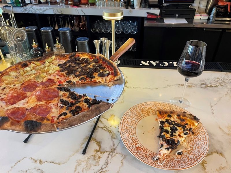 The Quattro Stagoni pizza from Patsy's Pizzeria of Bronxville, made with artichoke hearts, sauteed mushrooms, olives, baby arugula, sorpassata, mozzarella, tomato and pesto. Photographed Sept. 15, 2025