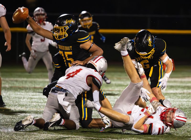 Irondequoit's Anthony Major, left, recovers a fumble Friday, Sept. 19 at West Irondequoit High School. Major returned the ball 55 yards for a touchdown.