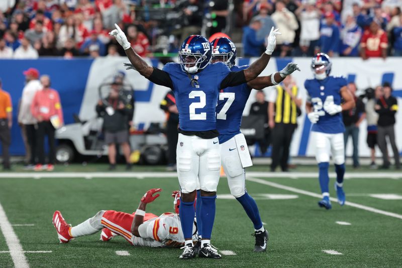 Sep 21, 2025; East Rutherford, New Jersey, USA; New York Giants cornerback Deonte Banks (2) and safety Tyler Nubin (27) react after a play against Kansas City Chiefs wide receiver Juju Smith-Schuster (9) in the second quarter at MetLife Stadium. Mandatory Credit: Vincent Carchietta-Imagn Images