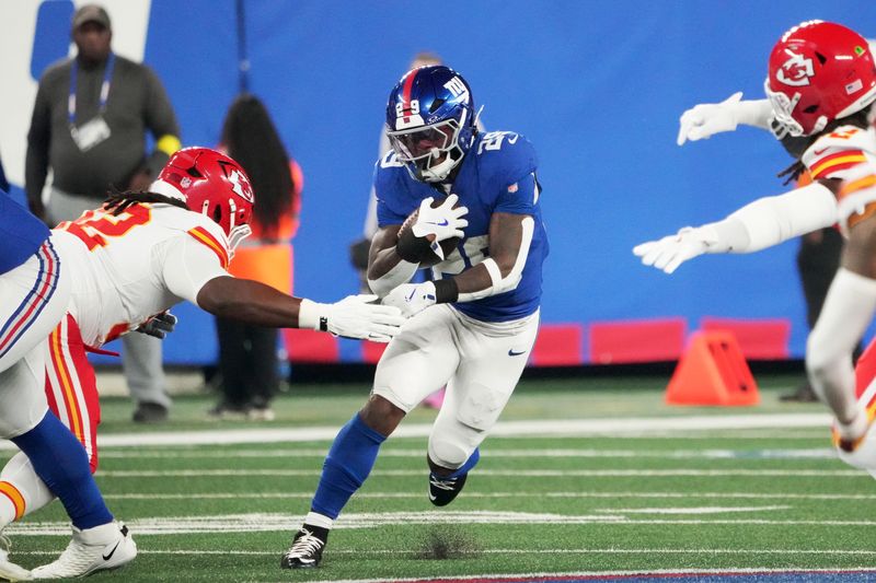 Sep 21, 2025; East Rutherford, New Jersey, USA; New York Giants running back Tyrone Tracy Jr. (29) runs against Kansas City Chiefs linebacker Nick Bolton (32) in the first quarter at MetLife Stadium. Mandatory Credit: Robert Deutsch-Imagn Images