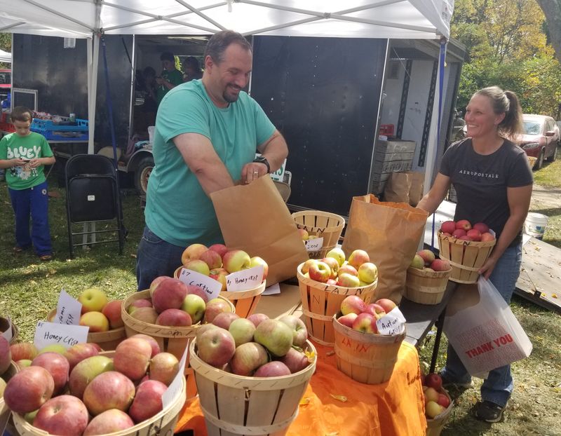 The team from Lain’s Cider Mill of Canisteo keep up with demand for fall treats at the Canaseraga Fall Harvest Festival.