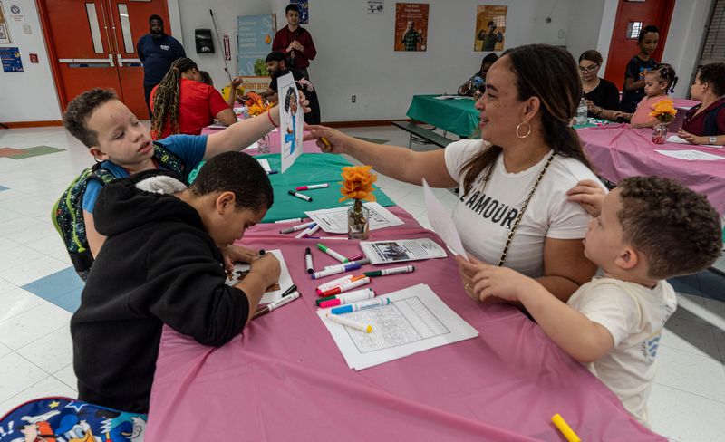 Romelia Perez and her children Emmanuel, 9, Angelo Tejada, 8, and Matthew Tejada, 4, color pictures together as they and other families take part in National Family Day festivities at the Grimes Elementary School in Mount Vernon Sept. 22, 2025. The school district, along with the Mount Vernon Youth Bureau, invited families to spend time together after school without their phones, tuned out from social media, and spending time coloring together, playing games, eating dinner.