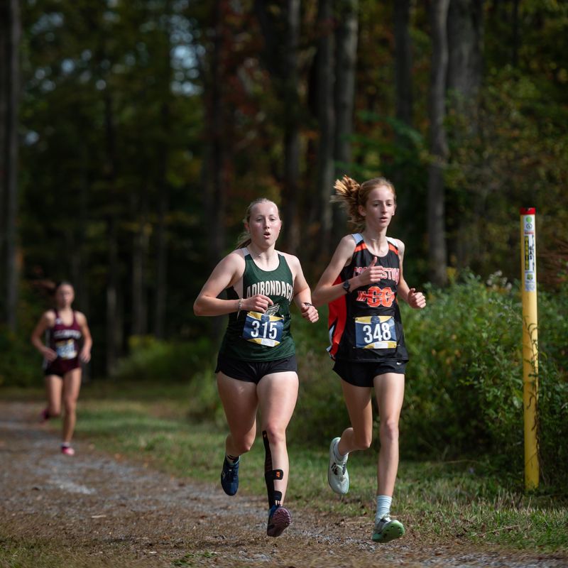 Adirondack’s Cora Hinsdill and Cooperstown’s Evelyn Rhodes compete in the 82nd E.J. Herrmann Cross Country Invitational at Utica's Thomas R. Proctor Park Saturday. Rhodes placed first and Hinsdill second among 103 runners in the small school girls varsity race.