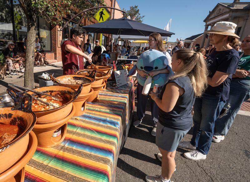People get food from Hacienda de Don Manuel Mexican restaurant during the second annual Suffern Spirit Day "Pride of America" street festival in downtown Suffern Sept. 28, 2025. The event included food, live music, pony rides, a rock climbing wall, a pumpkin patch, demonstrations by emergency response departments, and more.
