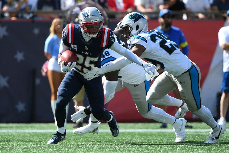 New England Patriots cornerback Marcus Jones returns a punt while Carolina Panthers cornerback Akayleb Evans defends during the first half at Gillette Stadium.