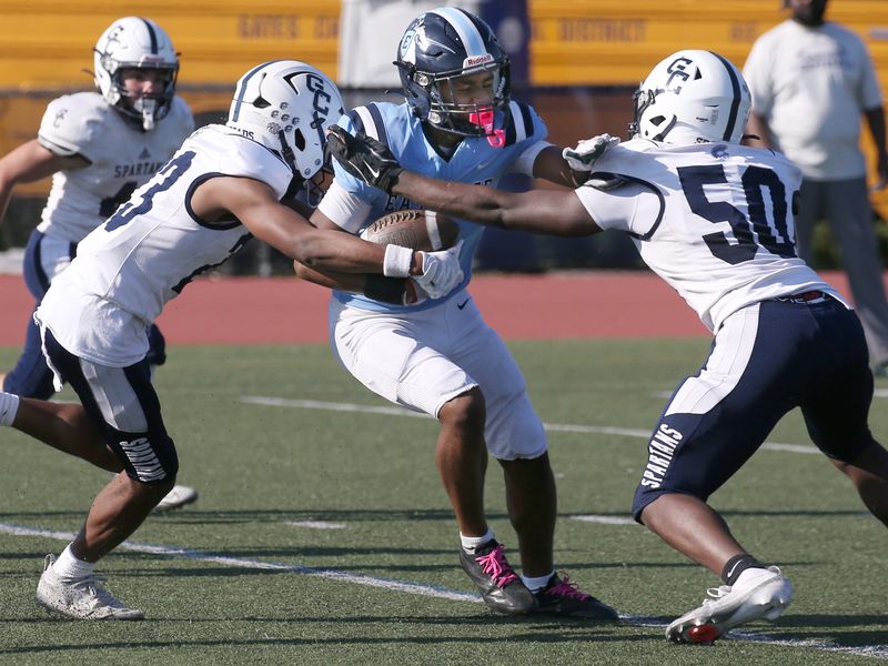 Gates Chili’s Lawrence Whitfield and Javier LaPorte combine to tackle Eastridge’s Justin Weathers during their Section V football matchup Saturday, Oct. 4, 2025 at Eastridge High School.
