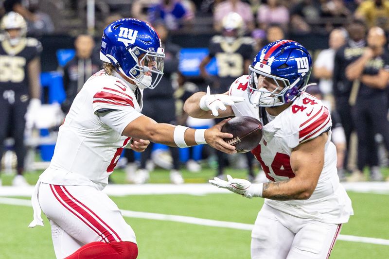 Oct 5, 2025; New Orleans, Louisiana, USA; New York Giants quarterback Jaxson Dart (6) hands off to running back Cam Skattebo (44) during the first half at Caesars Superdome. Mandatory Credit: Stephen Lew-Imagn Images