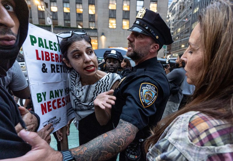 A Palestinian supporter, left, and a supporter of Israel are separated by police as they argue in Manhattan Oct. 7, 2025. Over one-thousand Palestinian supporters gathered in front of the headquarters of News Corporation, the home of Fox News, on the second anniversary of the Oct. 7 attacks by Hamas. A smaller number of Israel supporters were kept across the street by police,