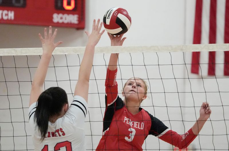 Penfield’s Sarah Petre pushes the ball past Hilton’s Taylor Green during their Section V girls volleyball divisional matchup Tuesday, Oct. 7, 2025 at Penfield High School.