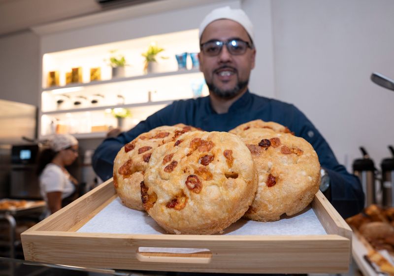 Chef/owner Thyago Raposo with a selection of round focaccia with cherry tomatoes and cheese at We Love Bread in Nyack. Wednesday, October 8, 2025. The bakery is participating in Nyack Restaurant Week.