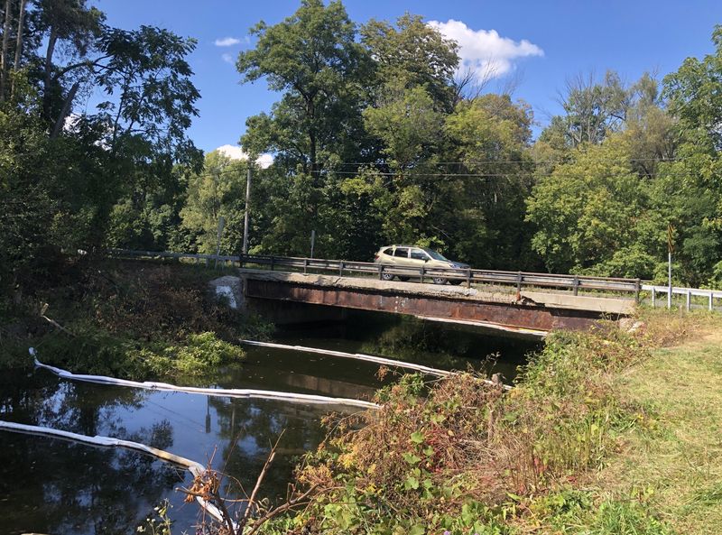 Flint Creek, pictured above with booms in the water shortly after an Aug. 30 fire at Eco Operations in Gorham, is once again open for fishing, boating and swimming.