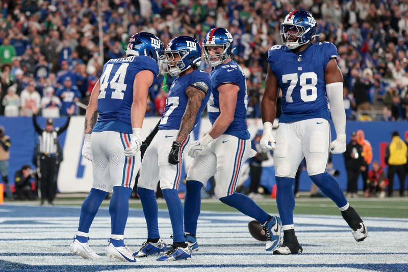 Oct 9, 2025; East Rutherford, New Jersey, USA; New York Giants running back Cam Skattebo (44) celebrates after scoring a touchdown against the Philadelphia Eagles with wide receiver Wan'Dale Robinson (17) during the second quarter of the game at MetLife Stadium. Mandatory Credit: Vincent Carchietta-Imagn Images