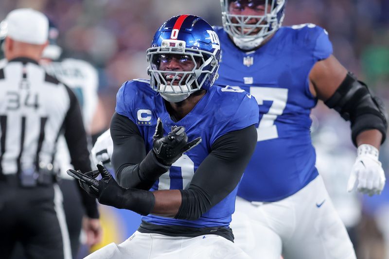 Oct 9, 2025; East Rutherford, New Jersey, USA; New York Giants linebacker Brian Burns (0) celebrates after a sack against the Philadelphia Eagles during the first quarter of the game at MetLife Stadium. Mandatory Credit: Brad Penner-Imagn Images