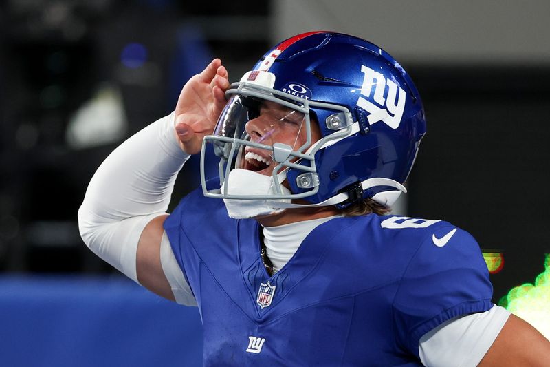 Oct 9, 2025; East Rutherford, New Jersey, USA; New York Giants quarterback Jaxson Dart (6) celebrates after scoring a touchdown against the Philadelphia Eagles of the game at MetLife Stadium. Mandatory Credit: Vincent Carchietta-Imagn Images