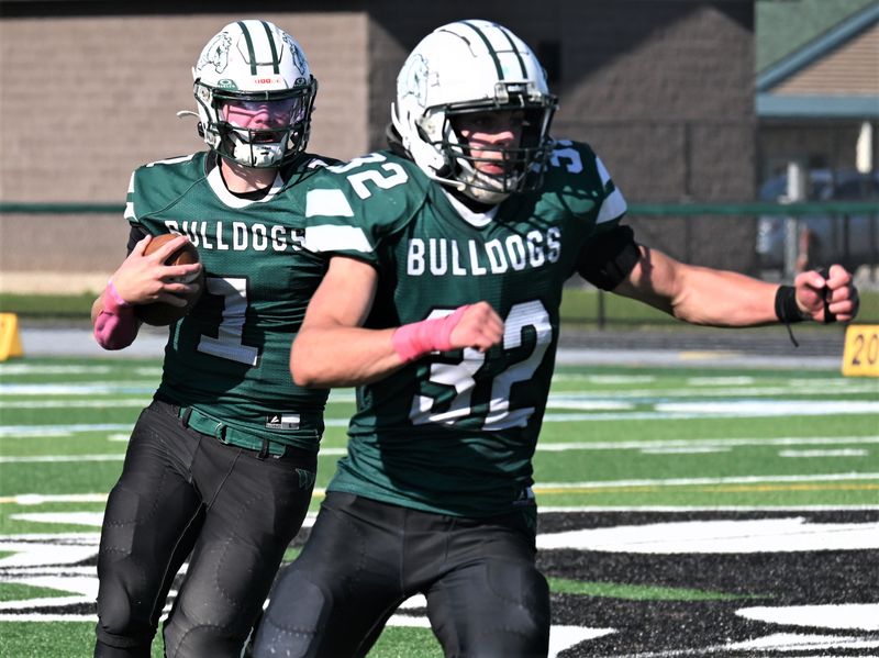 Westmoreland/Oriskany quarterback Dylan Williams (1) runs with the ball following fellow Bulldog Owen Smith's blocking Saturday against the Pulaski Blue Devils.