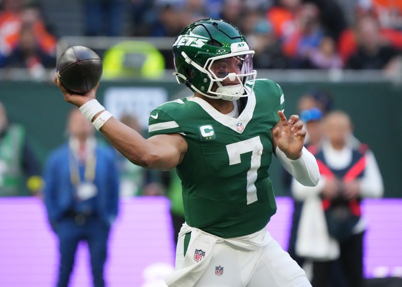 Oct 12, 2025; Tottenham, United Kingdom; New York Jets quarterback Justin Fields (7) throws a pass against the Denver Broncos during an NFL International Series game at Tottenham Hotspur Stadium. Mandatory Credit: Kirby Lee-Imagn Images