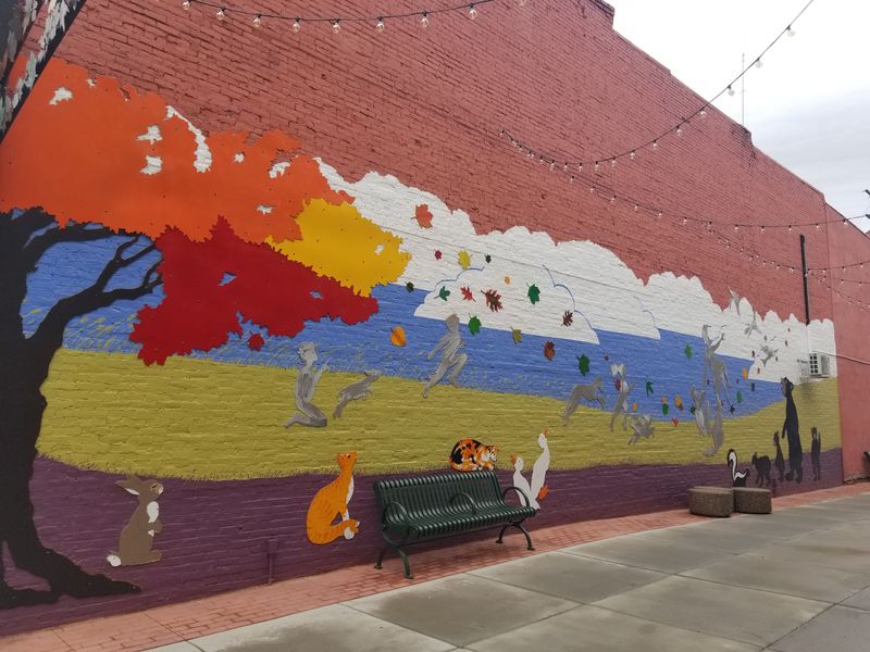 A new Hornell mural on Pave Alley adorns one side of the Lion’s Will music store. Artists Glenn Zweygardt and Christine Ehmann of Zweygardt Sculpture designed the mural which features people, animals and Hornell’s signature maple leaves.