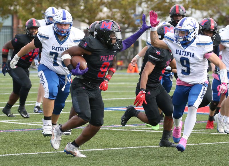Monroe defensive lineman Jermaine Montgomery stiff-arms Batavia’s Bronx Buchholz as he runs a recovered Batavia fumble in for Monroe touchdown in the second quarter during their Section V football divisional matchup Saturday, Oct. 18, 2025 at Monroe High School.