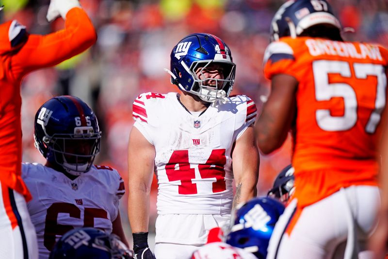 Oct 19, 2025; Denver, Colorado, USA; New York Giants running back Cam Skattebo (44) runs the ball against pressure from the Denver Broncos during the second half at Empower Field at Mile High. Mandatory Credit: Ron Chenoy-Imagn Images
