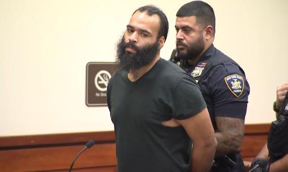 Louis Soto is escorted by a police officer after his arraignment on Oct. 17, 2025.