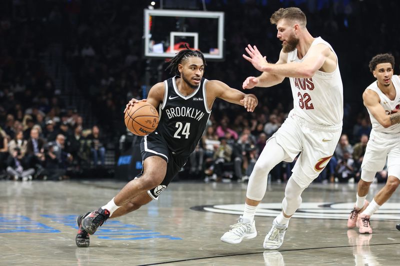 Oct 24, 2025; Brooklyn, New York, USA; Brooklyn Nets guard Cam Thomas (24) looks to drive past Cleveland Cavaliers forward Dean Wade (32) in the second quarter at Barclays Center. Mandatory Credit: Wendell Cruz-Imagn Images