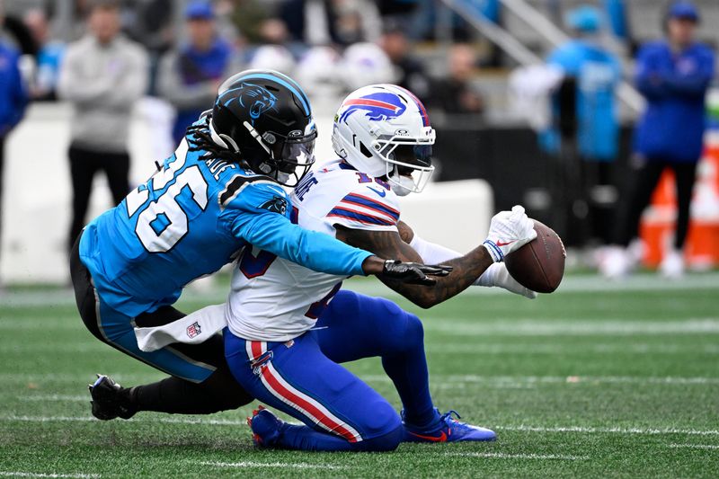 Oct 26, 2025; Charlotte, North Carolina, USA; Buffalo Bills wide receiver Elijah Moore (18) makes a catch against Carolina Panthers cornerback Chau Smith-Wade (26) in the fourth quarter at Bank of America Stadium. Mandatory Credit: Bob Donnan-Imagn Images