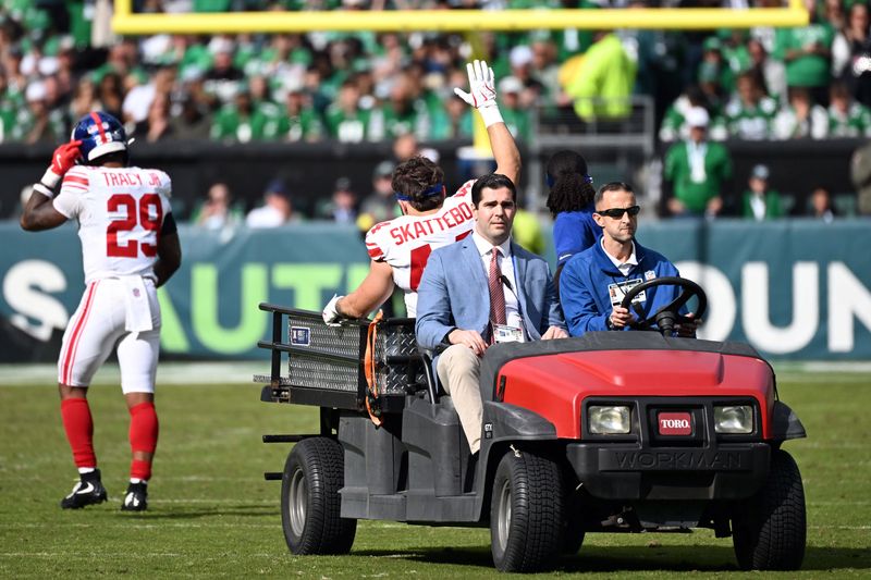 Oct 26, 2025; Philadelphia, Pennsylvania, USA; New York Giants running back Cam Skattebo (44) reacts as he is carted off the field after an injury in the second quarter against the Philadelphia Eagles at Lincoln Financial Field. Mandatory Credit: Eric Hartline-Imagn Images