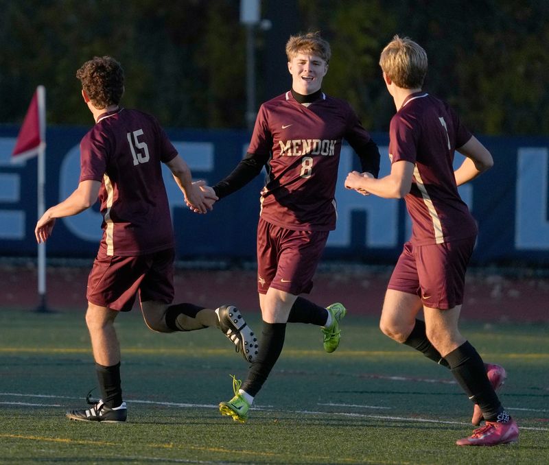 Mendon’s Benjamin Burrows, center, celebrates his first half goal with teammates Jack Healy and Colin Krohn during their Section V Class A boys soccer semifinal game Tuesday. Oct. 28, 2025 at Eastridge High School.