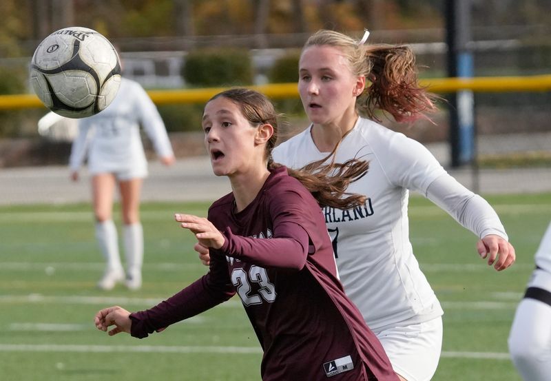 Aquinas’s Ava Barbone charges a loose ball ahead of Sutherland’s Cecily Kaul during their Section V Class A girls soccer championship finals Sat. Nov. 1, 2025 at Webster Schroeder High School.