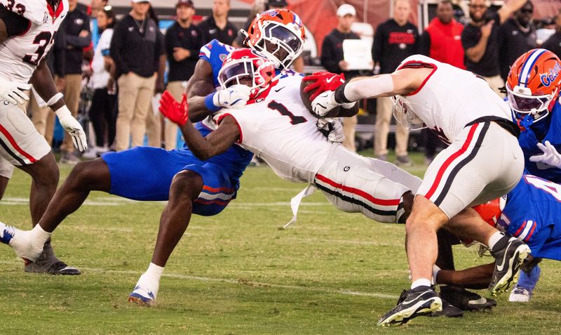 Florida Gators edge Kofi Asare (22) tackles Georgia Bulldogs wide receiver Zachariah Branch (1) in the second half in an NCAA football game, Saturday, Nov. 1, 2025, at EverBank Stadium in Jacksonville, Fla. Georgia defeated Florida 24-20. [Doug Engle/Florida Times-Union]