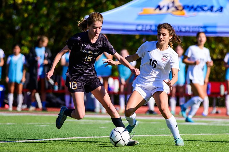 Pleasantville's Mary Kate Winn, left, and Rye's Jillian DeSanto battle for the ball during the Section 1 Class A girls soccer championship game at Nyack High School in Nyack, NY on Sunday, November 2, 2025.