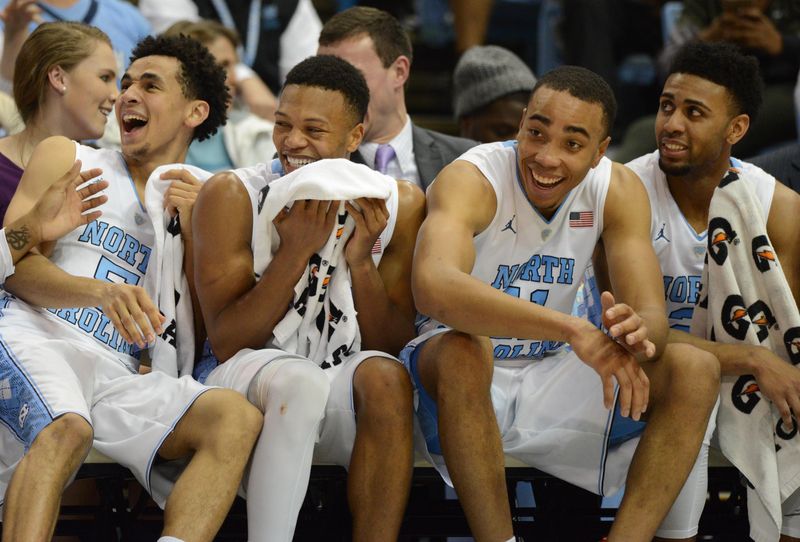 Dec 28, 2015; Chapel Hill, NC, USA; North Carolina Tar Heels guard Marcus Paige (5), Nate Britt(0), Brice Johnson (11), and Joel Berry II (2) laugh from the bench during the second half against the NC-Greensboro Spartans at Dean E. Smith Center. The Tar Heels won 96-63. Mandatory Credit: Rob Kinnan-USA TODAY Sports