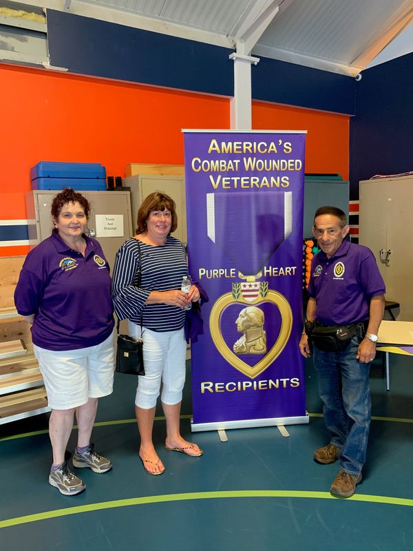New York State Assemblywoman Marianne Buttenschon (D 119th) poses with members of CNY Chapter #490 Military Order of the Purple Heart in a Flag Day Celebration Ceremony on June 14th 2025.