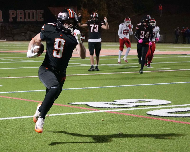 Mamaroneck’s Brian Auker (9) runs for a big gain against North Rockland during the Section 1 football Class AA semifinal at Mamaroneck High School Nov. 7, 2025. Mamaroneck won the game 54-20.