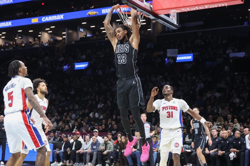 Nov 7, 2025; Brooklyn, New York, USA; Brooklyn Nets center Nic Claxton (33) dunks in the fourth quarter against the Detroit Pistons at Barclays Center. Mandatory Credit: Wendell Cruz-Imagn Images