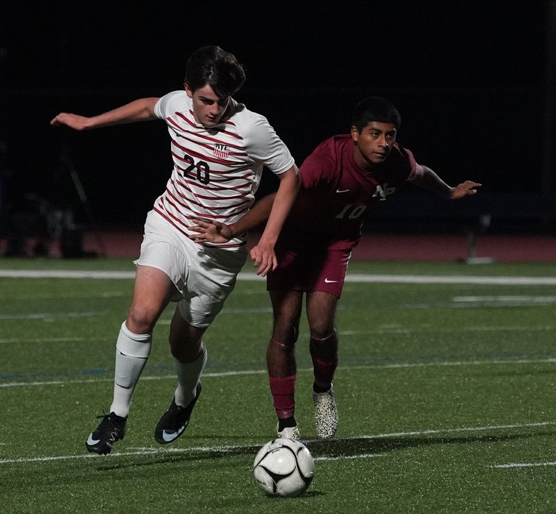 Rye's Alec Dodge Terra (20) works around New Paltz's Luc Saguilan (10) during their 5-0 win in the Class A boys soccer regional semifinal at Goshen High School on Wednesday, November 5, 2025.