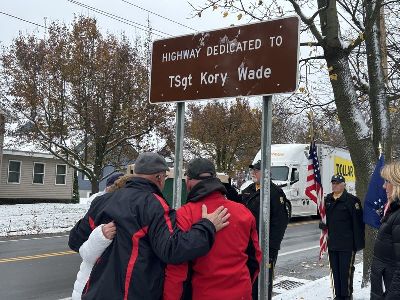 Assemblyman Jeff Gallahan, R-Manchester, who championed the bill to designated the portion of Route 21 in Tech. Sgt. Kory Wade's honor, stands in front of the unveiled sign with Wade's parents, Mike Wade and Jill Sauer-Betz.