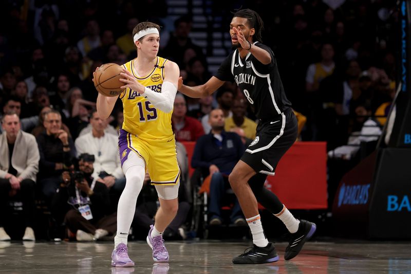 Mar 10, 2025; Brooklyn, New York, USA; Los Angeles Lakers guard Austin Reaves (15) looks to pass the ball against Brooklyn Nets forward Ziaire Williams (8) during the fourth quarter at Barclays Center. Mandatory Credit: Brad Penner-Imagn Images
