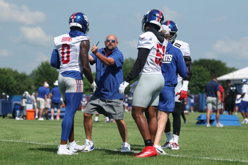 Jul 23, 2025; East Rutherford, NJ, USA; New York Giants head coach Brian Daboll instructs linebacker Brian Burns (0) and linebacker Abdul Carter (51) during drills during training camp at Quest Diagnostics Training Center. Mandatory Credit: Vincent Carchietta-Imagn Images