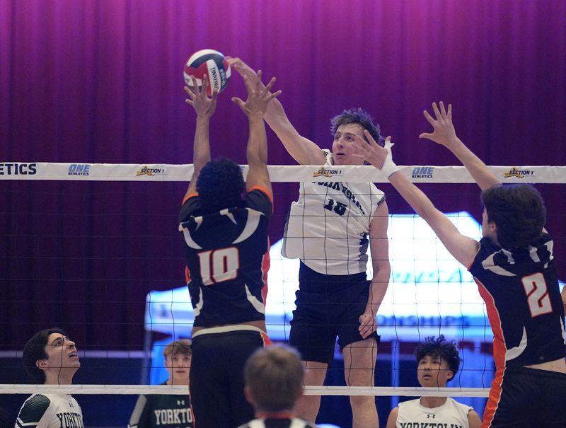 Yorktown's Franklin Ringel (15) works a shot past Croton/Briarcliff/Hen Hud's Yanik Ekambaram (10) during the Section 1 Division 2 Boys Volleyball Championships at the Westchester County Center in White Plains on Thursday, November 13, 2025. Yorktown won 3-1.