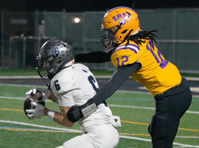 Brighton’s Patrick Rohr intercepts a pass intended for East’s Junayde Dunn-Richardson late in the fourth quarter.