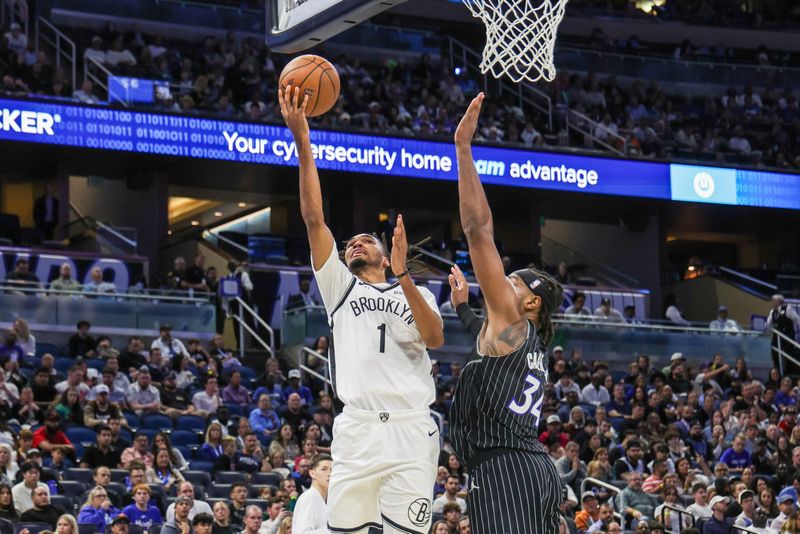 Nov 14, 2025; Orlando, Florida, USA; Brooklyn Nets forward Ziaire Williams (1) goes to the basket against Orlando Magic center Wendell Carter Jr. (34) during the second quarter at Kia Center. Mandatory Credit: Mike Watters-Imagn Images