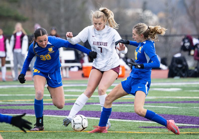 Albertus Magnus' Teigan Cunnane takes on West Islip's Julianna Arcoleo, left, and Ava Bianca during the NYSPHSAA Class AA semifinals Saturday, Nov. 15 at Dryden High School.